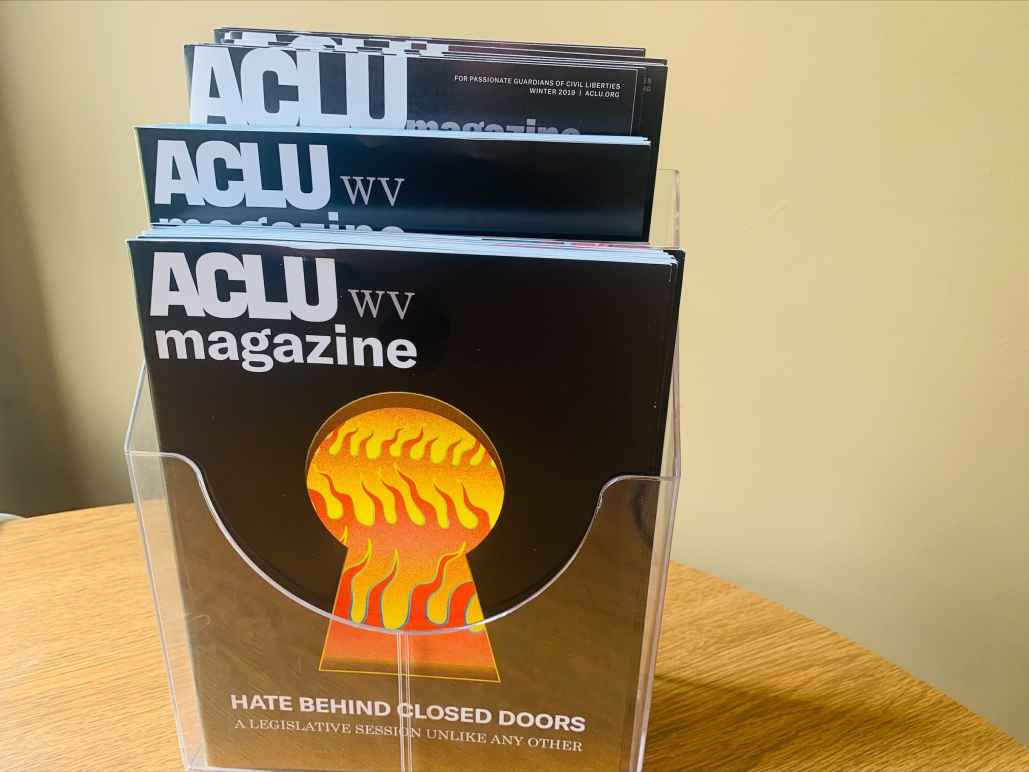 2021 ACLU-WV Magazine cover features image of flames seen through a keyhole with the words: Hate Behind Closed Doors