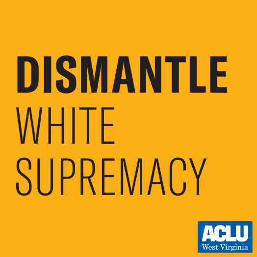 Black text on a gold background says "Dismantle White Supremacy."