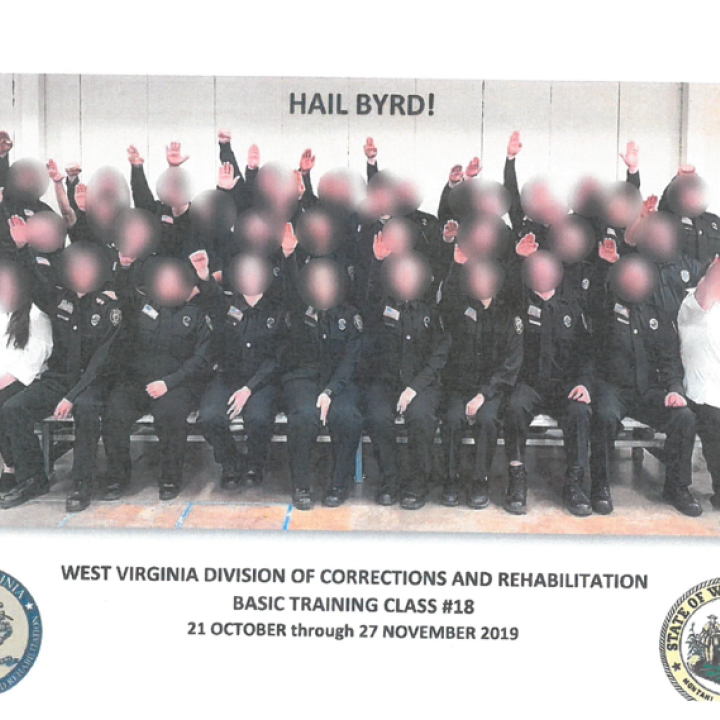 Photo shows a class of WV Corrections cadets, arms raised in a Nazi salute. Faces are blurred.