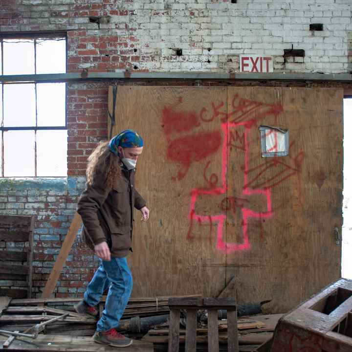 Dominique Miller searches an abandoned building for people using it as shelter. 