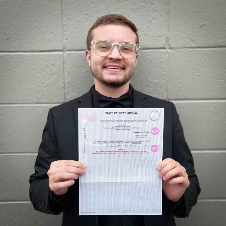 Xavier Hersom holds a picture of his birth certificate